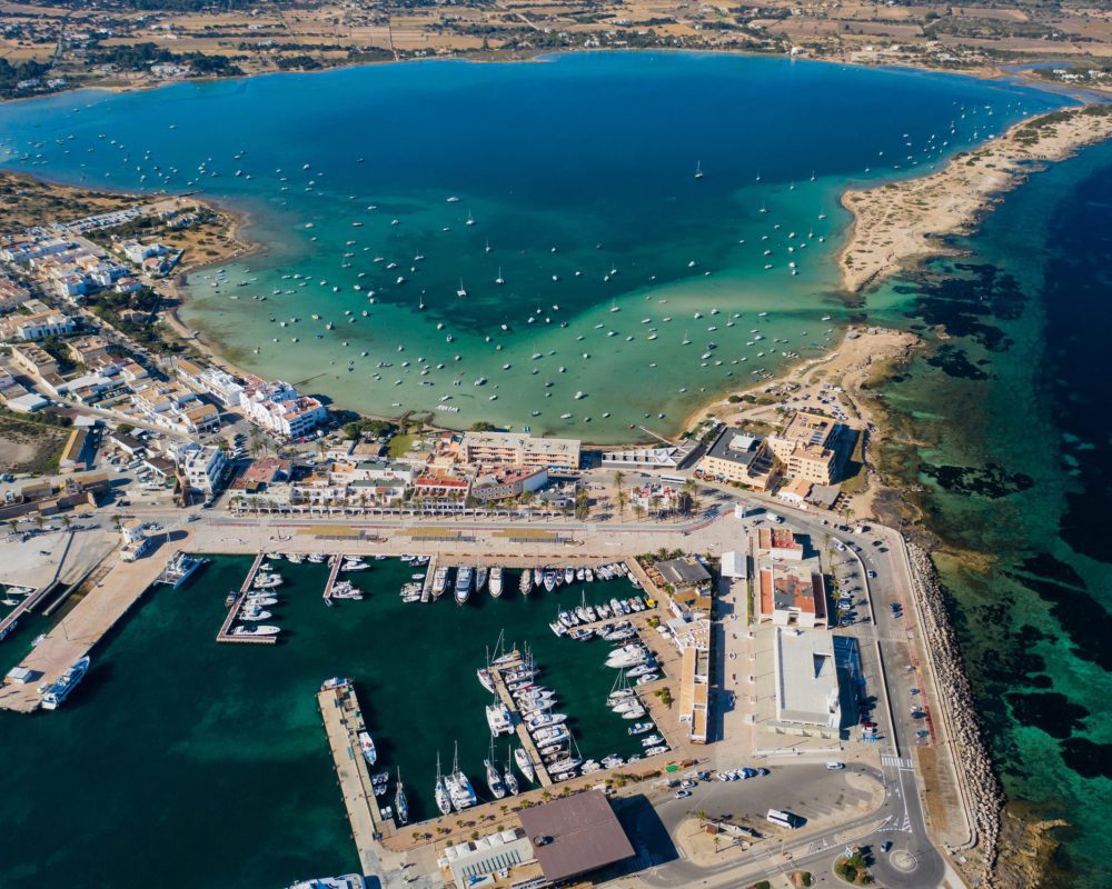 Beautiful turquoise bay at Formentera, aerial view. Snow-white yachts near the coast.